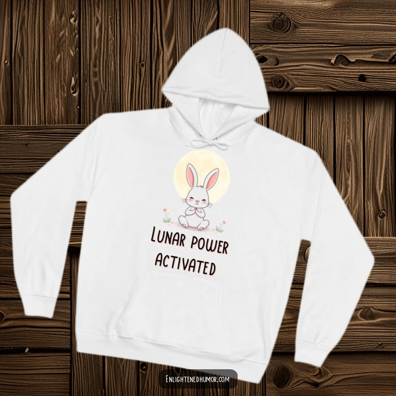 Funny hoodie featuring a determined rabbit meditating under a giant, serene moon, offering humorous warmth and tranquility.