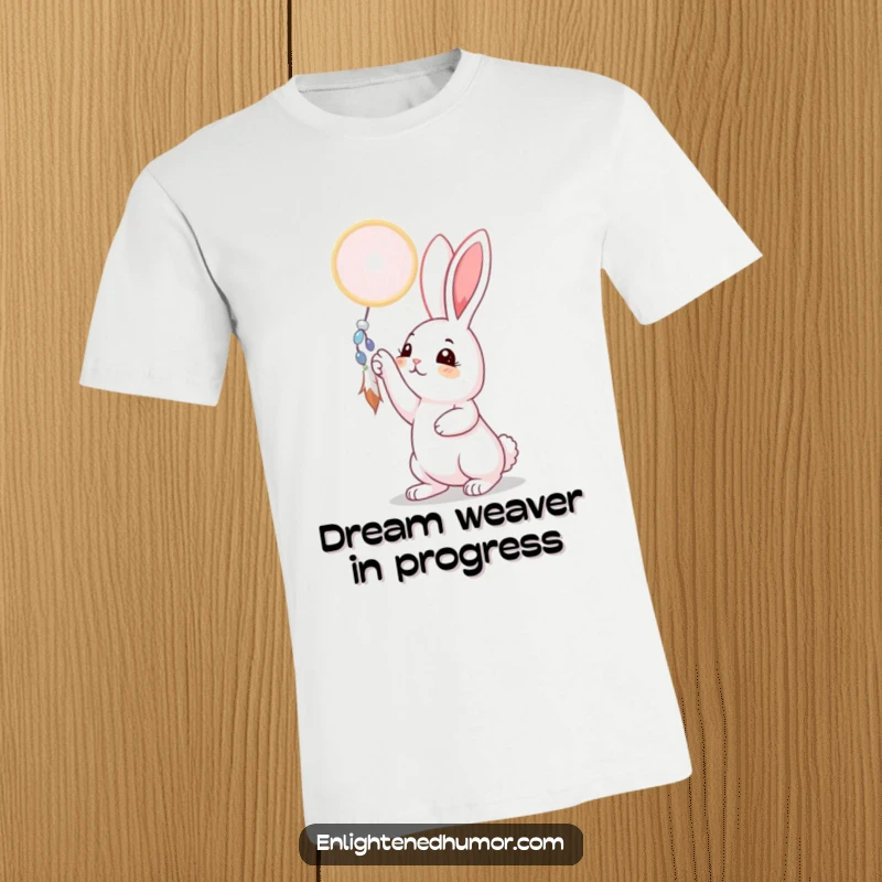 Funny rabbit t-shirt with a curious expression reaching for a shimmering dreamcatcher, symbolizing hope and dreams, perfect for animal lovers and whimsical gift seekers.