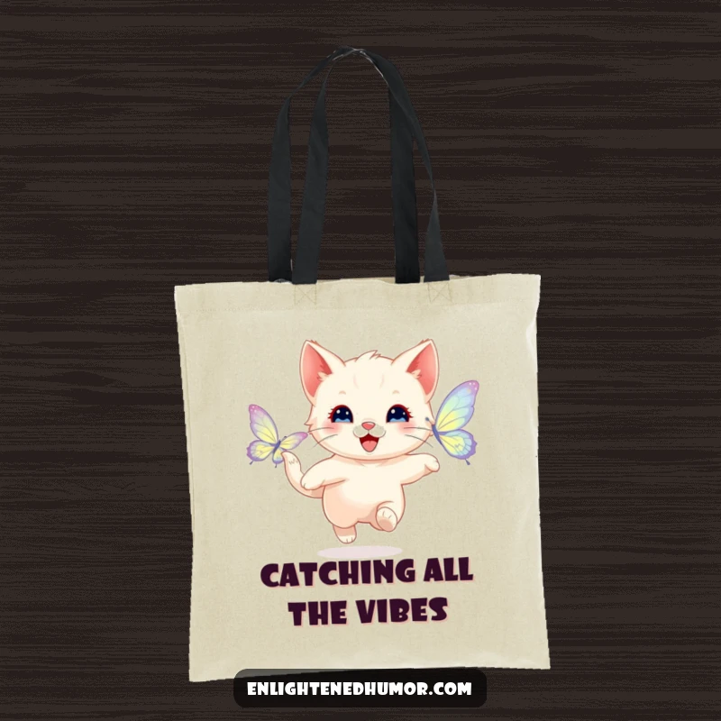 Funny tote bag showcasing a happy kitten playfully chasing a shimmering butterfly with radiant wings, perfect for stylish and fun everyday use.